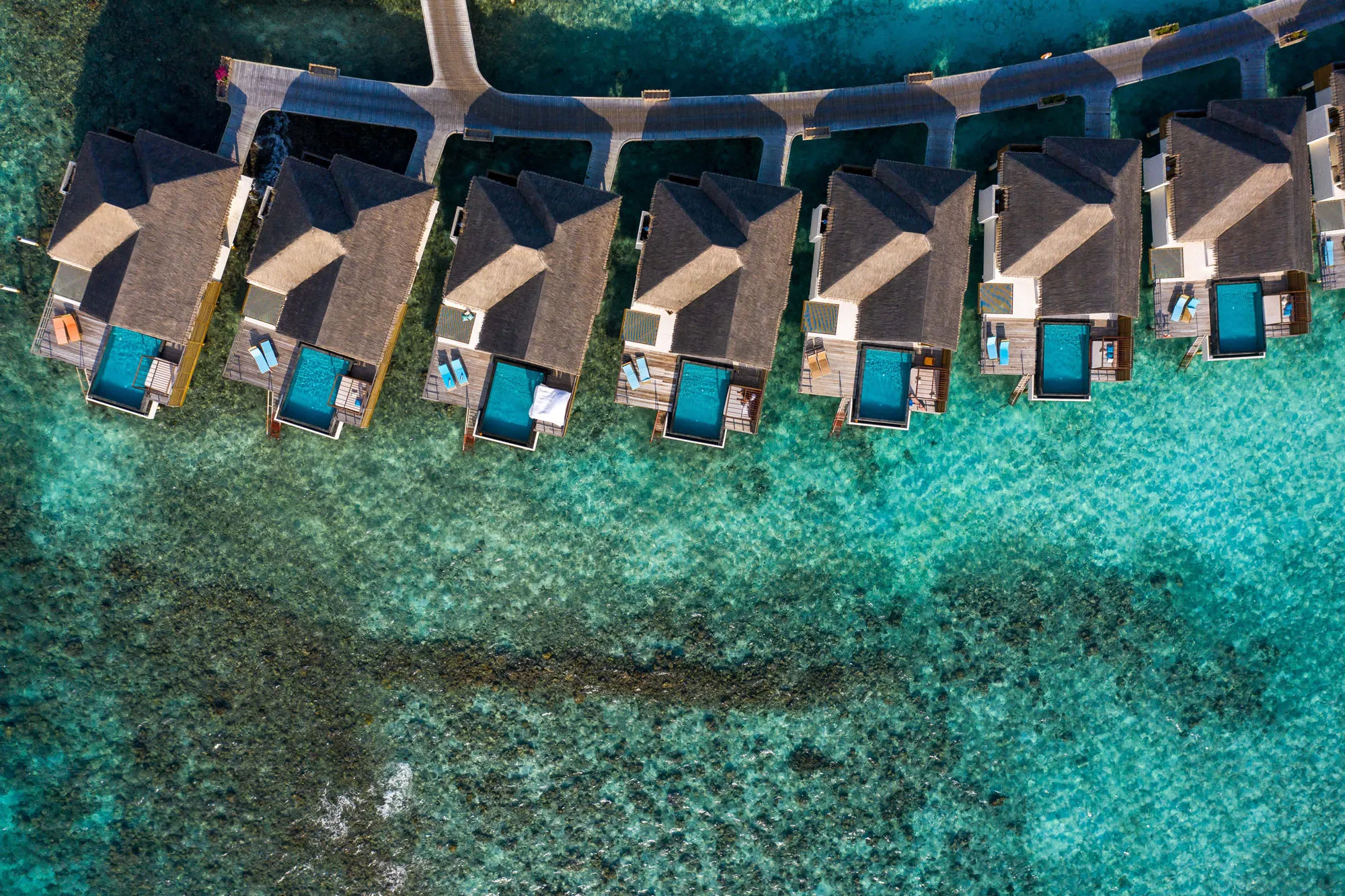 Row of overwater villas with private pools in the Maldives